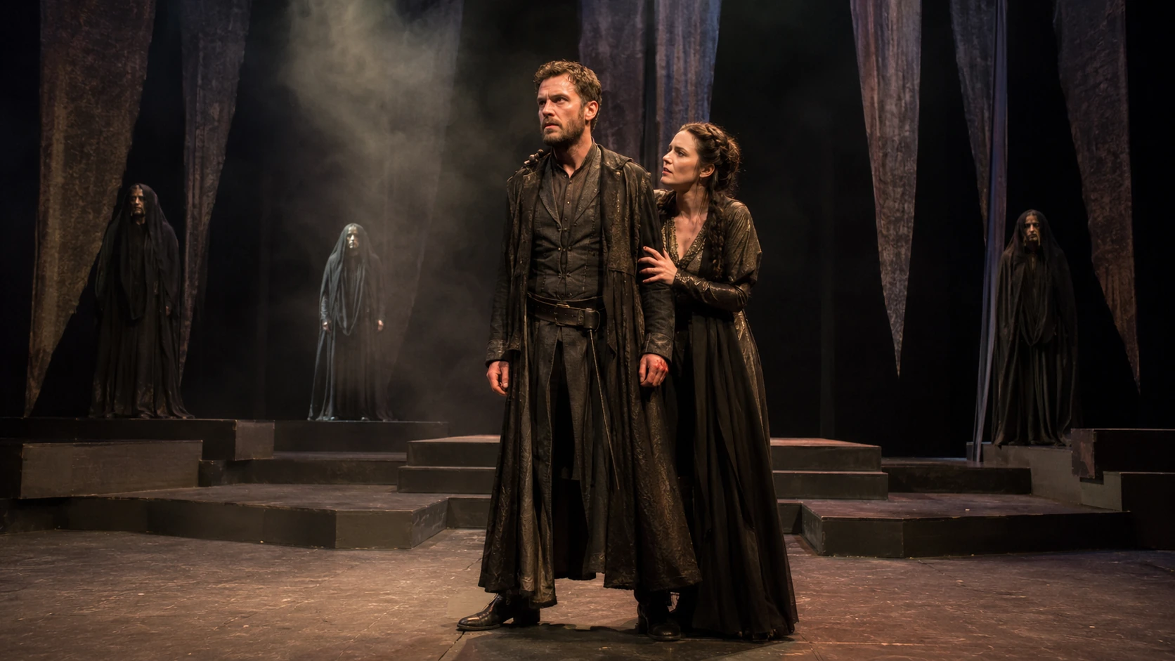 A stageable Macbeth production concept with Macbeth and Lady Macbeth centre stage and three veiled supernatural figures occupying raised levels behind them.